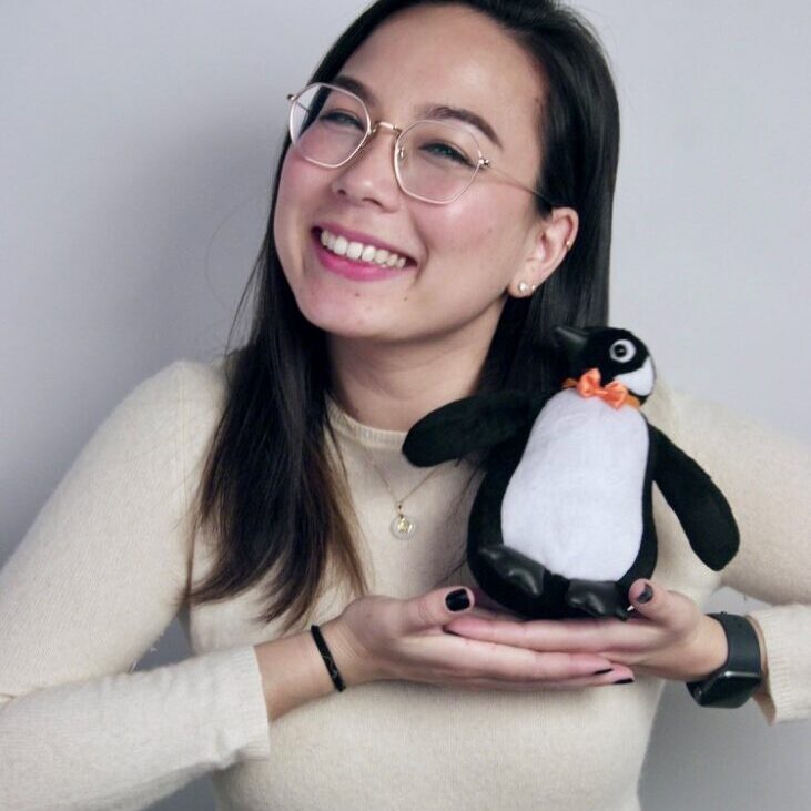 KES holding a stuffed penguin.